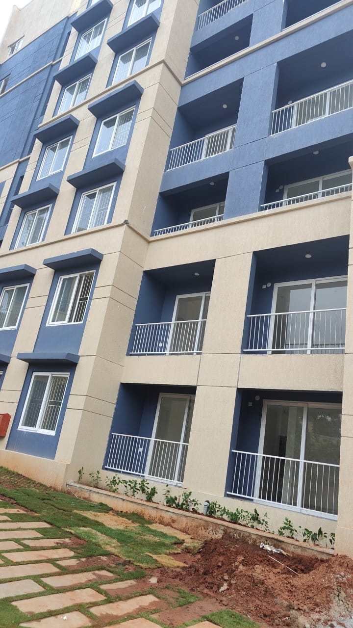 East-facing 1BHK flat for sale in Mogappair West, 682 sqft in a gated community with lift and car parking.
